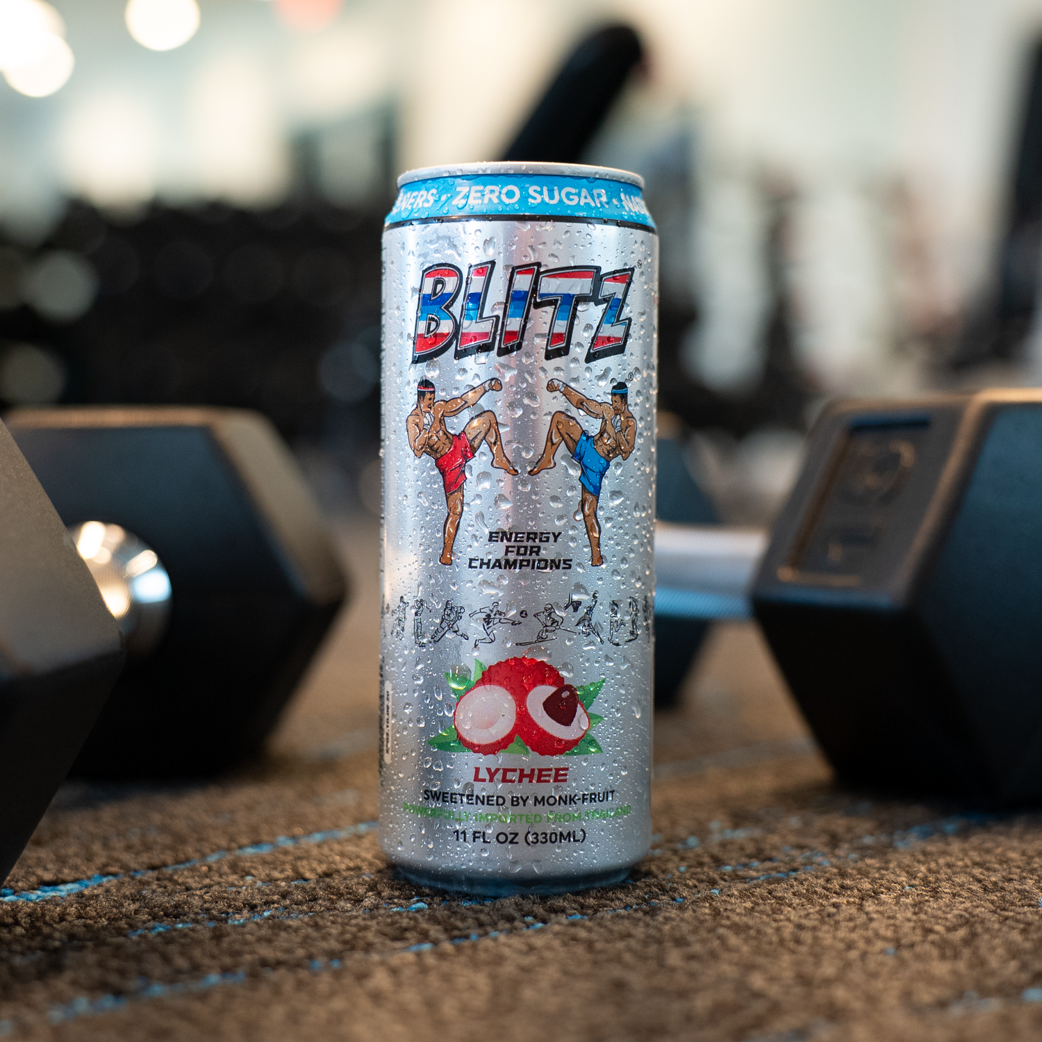 Blitz energy drink can on a gym floor with weights in the background